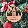 Suspension de Noël personnalisée Manoa gravée en bois, avec lutin festif et biscuits de pain d’épices, accrochée dans un sapin.
